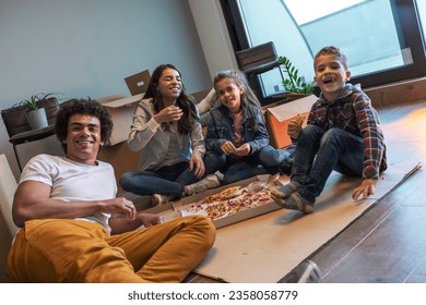 Mixed race family moving into their new home. Taking a break after unpacking and ordered pizza to eat.	 - Powered by Shutterstock