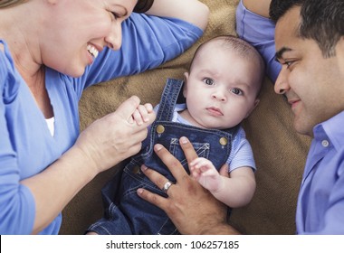 Mixed Race Family Playing Face Up on the Blanket. - Powered by Shutterstock