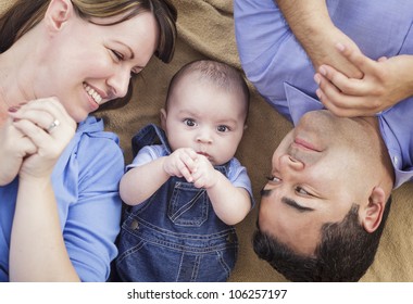 Mixed Race Family Playing Face Up on the Blanket. - Powered by Shutterstock