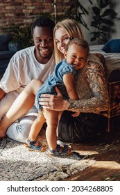 Mixed Race Family Posing Together On Camera Inside Room