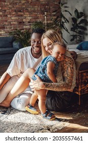 Mixed Race Family Posing Together On Camera Inside Room