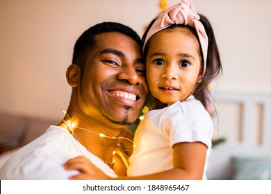 Mixed Race Family Spending Holiday In The Bed In Bedroom Christmas Morning