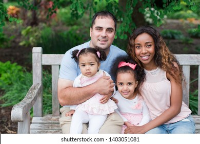 Mixed race family together in park