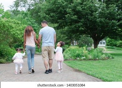 Mixed race family together in park