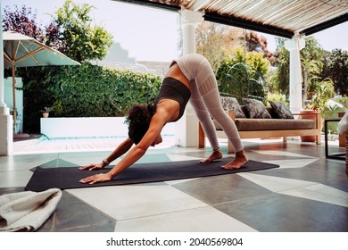 Mixed Race Female Downward Dog Stretching Practicing Yoga Outside Home