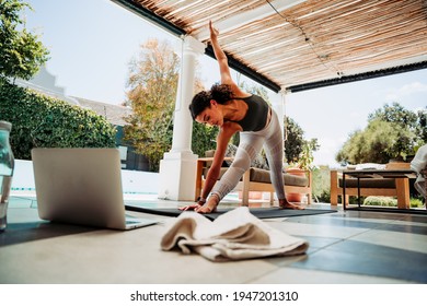 Mixed Race Female Stretching Legs Practicing Yoga Outside Home 