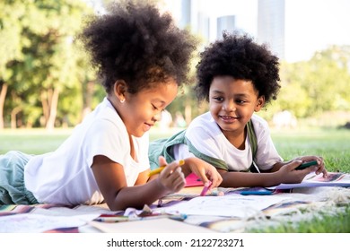 Mixed race girl   boy are drawing   painting in the park  They use their imagination   creativity in art  Learning ideas outside the classroom 
