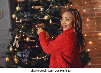 Mixed Race Girl Near Christmas Tree At Home