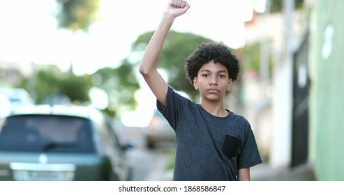 Mixed Race Kid Raising Fist In The Air Political Protest