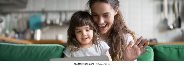 Mixed race mother and daughter using computer make video call waving hands greeting friend, having fun online modern tech applications concept banner for website header design with copy space for text