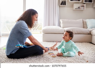 Mixed Race Mum And Toddler Son Playing In Sitting Room