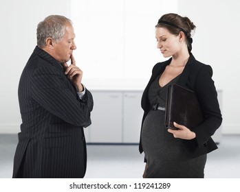 Mixed race pregnant businesswoman with thoughtful senior boss - Powered by Shutterstock