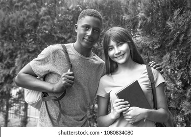 Mixed Race Teenagers Couple Embracing Outdoor. Integration Concept.