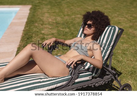 Similar – Brunette surfer woman in bikini standing with surfboard