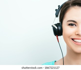 Mixed Race Woman With Toothy Smile Getting A Hearing Test, Audiometer Hearing Test. Half Face, On Gray Background