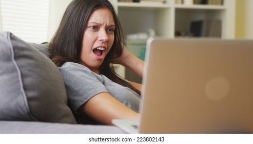 Mixed Race Woman Watching Horror Show On Laptop