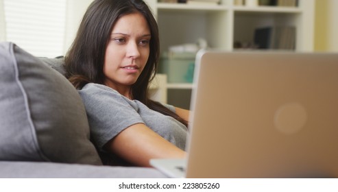 Mixed Race Woman Watching Horror Show On Laptop