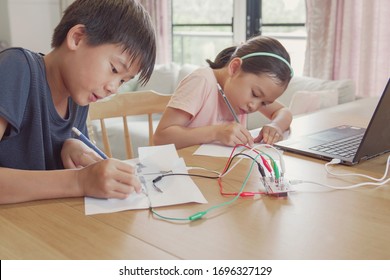 Mixed Race Young Asian Children Learning Coding Together, Learning Remotely At Home, STEM Science, Homeschooling Education, Social Distancing, Isolation Concept