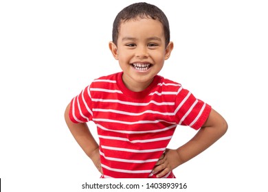 A mixed race young boy laughs while looking at the camera. The toddler wears a red white striped shirt as he smiles at the camera with hands on his hips.