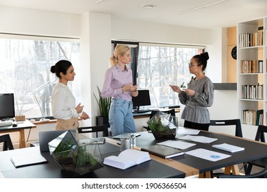 Mixed Raced Team Of Managers Discussing Work Issues In Meeting Room. Diverse Group Of Employees Or Interns Talking During Training Break. Busy Office Colleagues Having Briefing By Conference Table