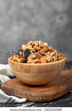Mixed raw nuts. Special mixed nuts in bowl. Hazelnut, almond, cashew, pistachio, dried blueberry. Superfood. Vegetarian food concept. healthy snacks. Close up