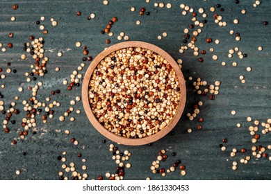 mixed raw quinoa in bowls on wooden background. Healthy and gluten free food. Origin Peru, banner, menu, recipe, place for text. top view.