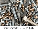 Mixed screws and nails. Industrial background. Home improvement.bolts and nuts.Close-up of various screws. Use for background, top view.