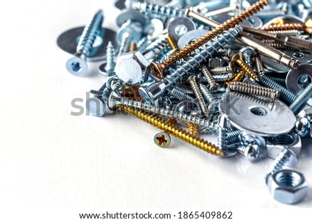 Mixed screws and nails. Industrial background. Home improvement.bolts and nuts.Close-up of various screws. Use for background, top view.