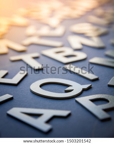 Mixed solid letters pile closeup photo. Education background concept