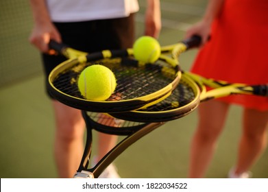 Mixed tennis, players with rackets and balls - Powered by Shutterstock