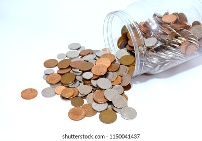 Mixed UK Currency Coins Tipped Out Of A Jar