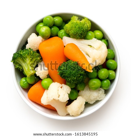 Mixed vegetables in white ceramic bowl isolated on white. Top view.
