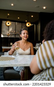 Mixed Woman Enjoying A Night Out Downtown At A Hotel Bar With Friends