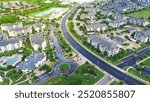 Mixed-use development area with pond water fountain, apartment complex, residential neighborhood, industrial zoning warehouses in fast growing area Pflugerville northeast of downtown Austin, TX. USA