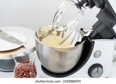 Mixer Bowl Of Whipped Cream. White Kitchen Background. Homemade Culinary Concept. Mixing, Whipping Cream For Cake. Concept Of Confectionery, Cooking Desserts And Kitchenware, Homemade Culinary.