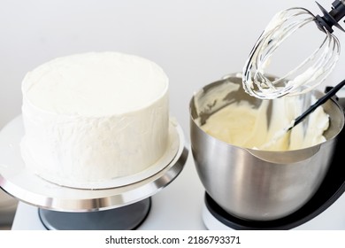 Mixer Bowl Of Whipped Cream. White Kitchen Background. Homemade Culinary Concept. Mixing, Whipping Cream For Cake. Concept Of  Confectionery, Cooking Desserts And Kitchenware