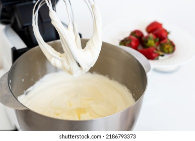 Mixer Bowl Of Whipped Cream. White Kitchen Background. Homemade Culinary Concept. Mixing, Whipping Cream For Cake. Concept Of  Confectionery, Cooking Desserts And Kitchenware