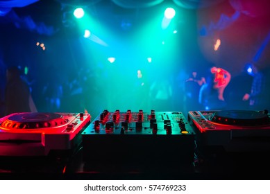mixer and a DJ booth in the nightclub at a party with a diffuse bright background