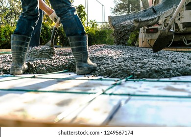Mixer track pouring wet cement to the civil building foundation. Construction workers in the process of forming house concrete slab at the construction site.    - Shutterstock ID 1249567174