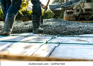Mixer track pouring wet cement to the civil building foundation. Construction workers in the process of forming house concrete slab at the construction site.    - Shutterstock ID 1249567183