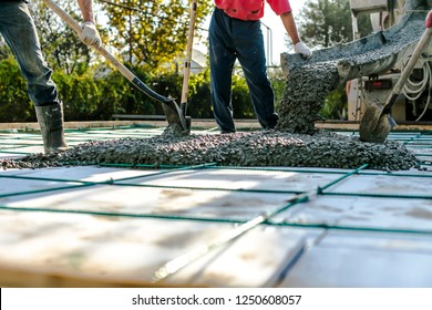 Mixer track pouring wet cement to the civil building foundation. Construction workers in the process of forming house concrete slab at the construction site.    - Shutterstock ID 1250608057