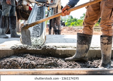 Mixer Truck Pouring Cement For Ground Formworking At Construction Site. Worker Using Shovel And Scoop At Work Place.