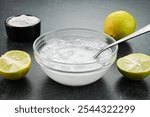 Mixing baking soda with water and lemon.