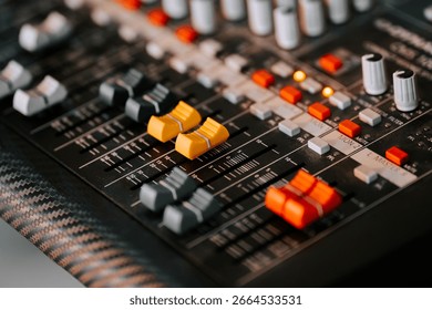 Mixing board with colorful knobs and sliders in a recording studio