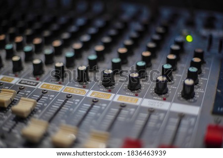 Mixing Board Sound Knobs. Pro audio mixing board faders and knobs, multi-track music recording equipment.