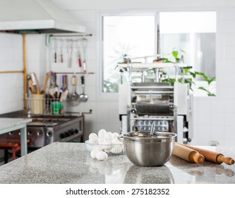 Mixing Bowl With Eggs And Rolling Pin On Counter In Commercial Kitchen