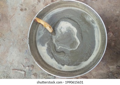 Mixing Cement In A Metal Bowl.