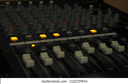 Mixing console sliders and knobs.