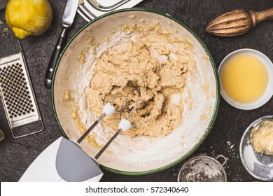 Mixing Dough With Hand Mixer On Kitchen Table Background With Cooking Ingredients, Top View
