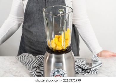 Mixing Ingredients In Kitchen Blender To Prepare Mango Boba Smoothie.